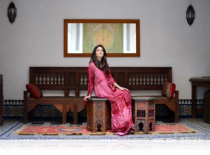 photo of a woman in a long red dress shot indoors