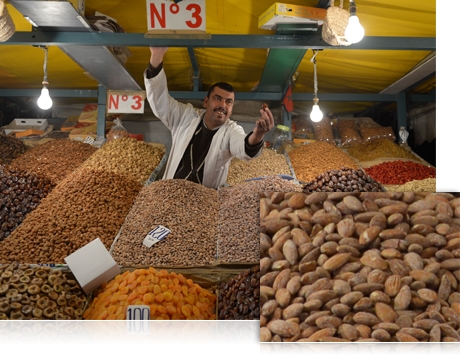 photo of a man selling nuts at a market, and a closeup view of nuts
