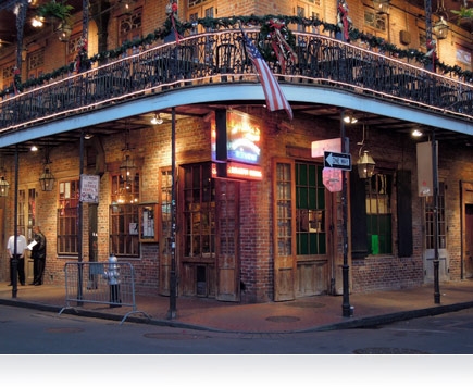 Nighttime photo of a corner building in New Orleans, Louisiana