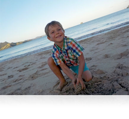 low light photo of a mom and kids looking out over the water highlighting CMOS sensor