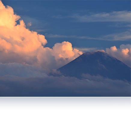 Nikon D610 photo of a mountain peak jutting above the clouds
